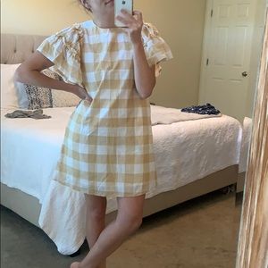 Gingham shift dress with ruffle detail sleeve.